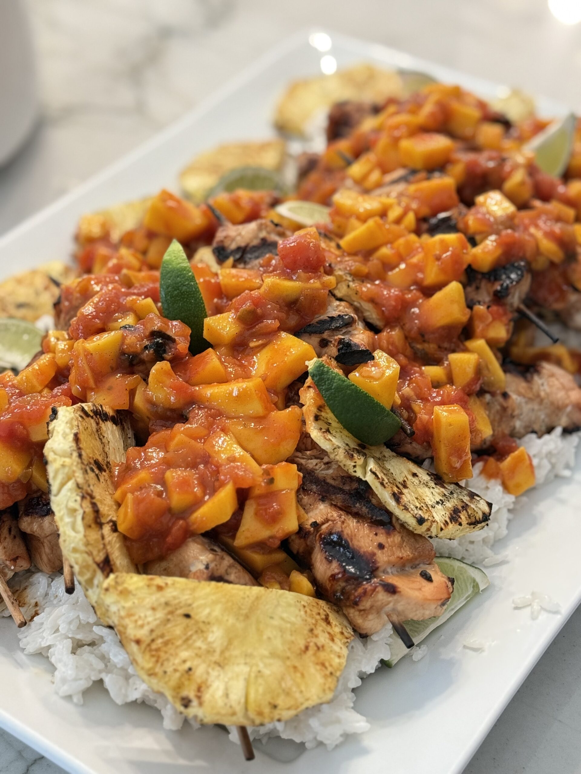 crack on chicken skewers over coconut rice and mango salsa