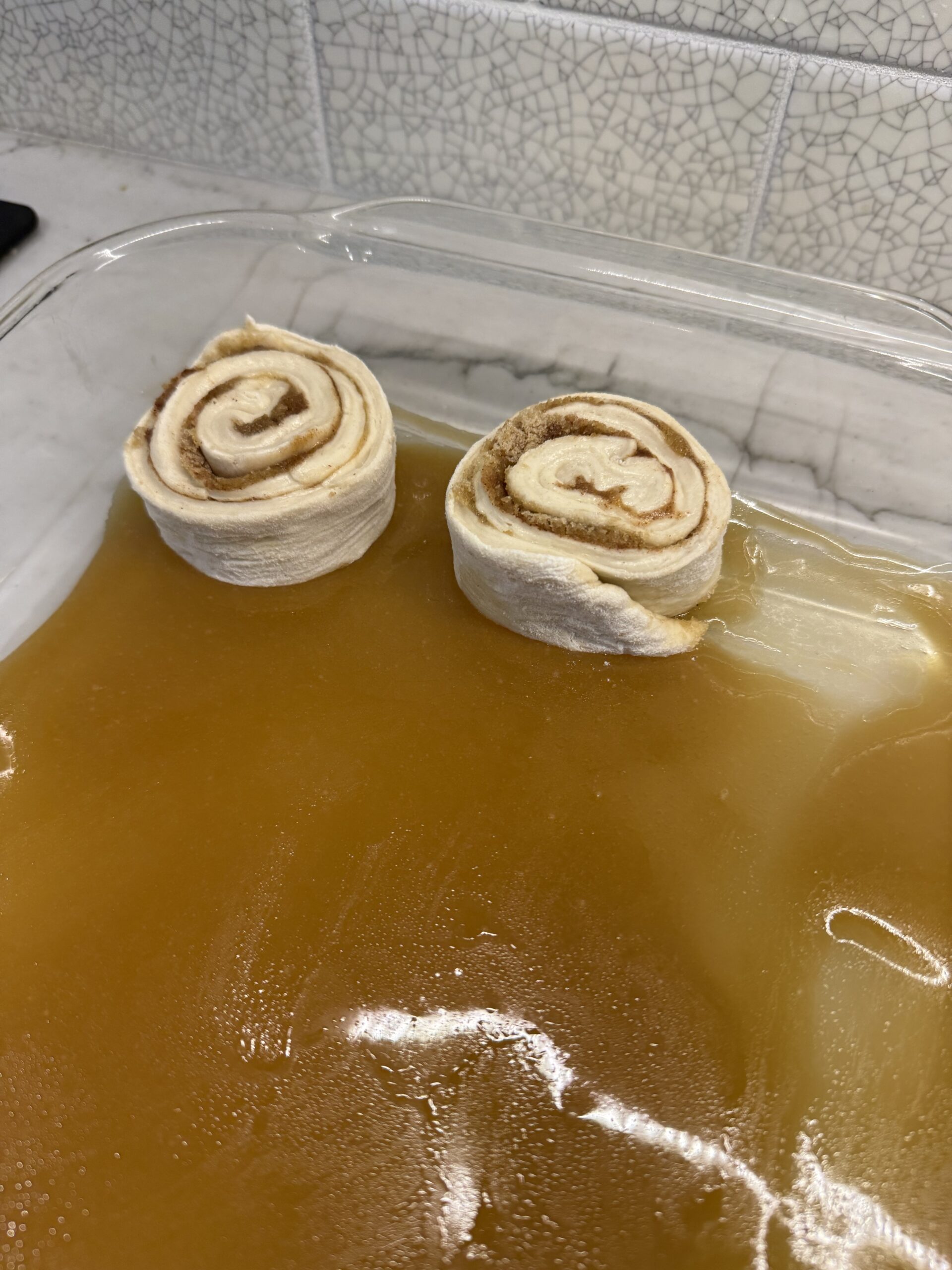 place cinnamon buns on sticky sauce