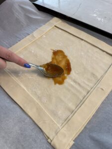 Spread jam on base of tart