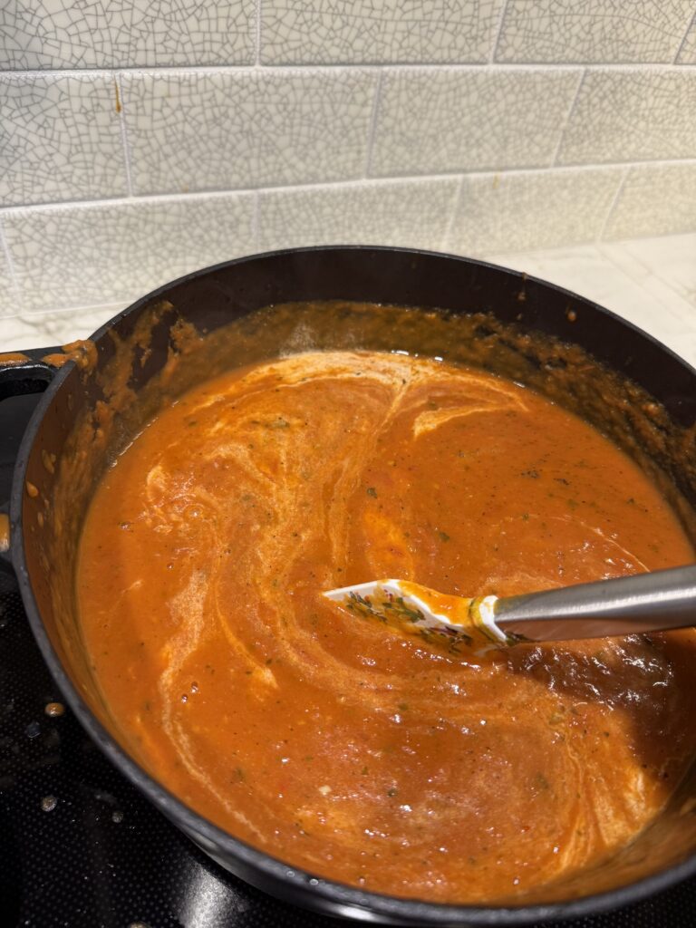stirring in cream to tomato soup